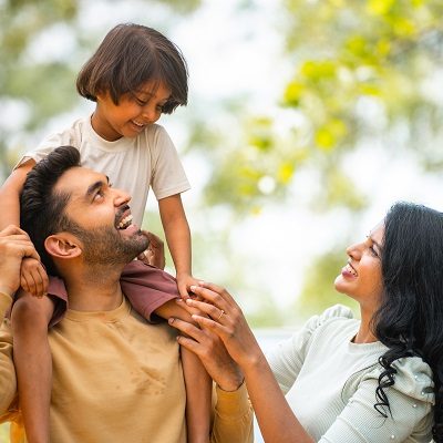 Happy,Indian,Parents,Playing,With,Daughter,While,Kid,On,Father